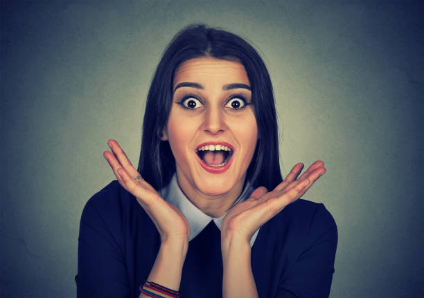 istock Surprised young woman shouting over gray background. Looking at camera 666119832