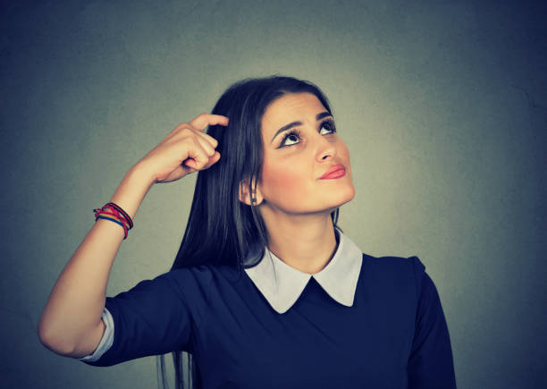 istock confused thinking young woman bewildered scratching her head 666119974