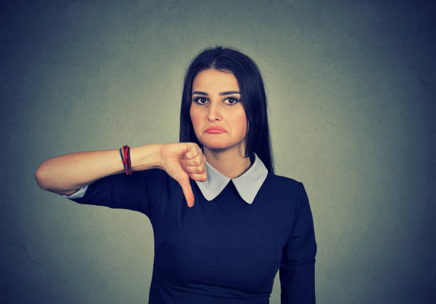 istock Unhappy woman giving thumb down gesture 666122024
