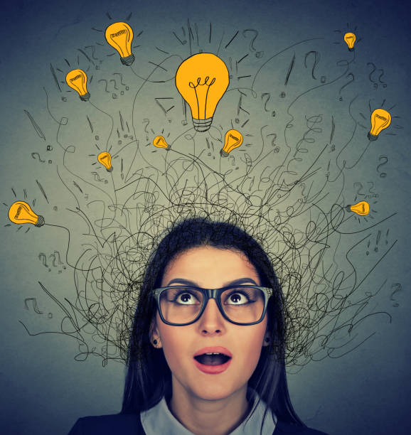 istock Woman with many ideas light bulbs above head looking up 666122234