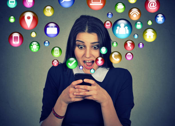 istock surprised young woman using texting on smartphone 666122282