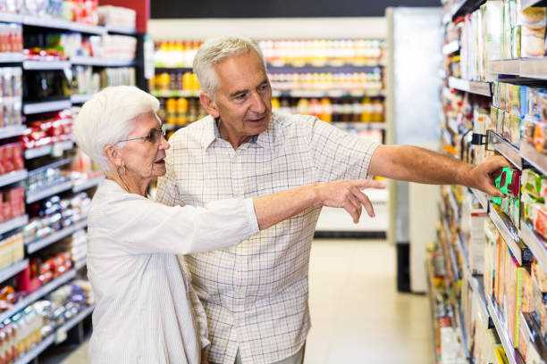 istock Happy senior couple choosing food 666134764