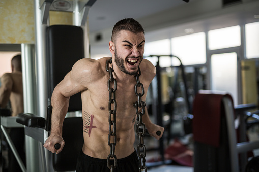 Bodybuilder showing his muscles