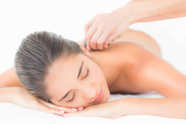 istock Beautiful brunette enjoying a hot stone massage 666149582