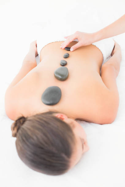 istock Pretty brunette enjoying a hot stone massage 666149864