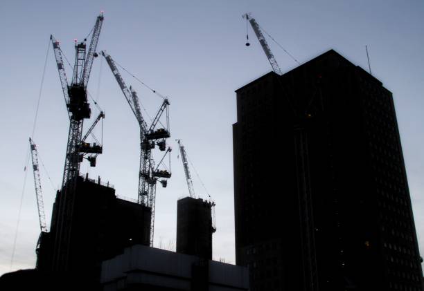 istock Silhouette of cranes and buildings 666152650