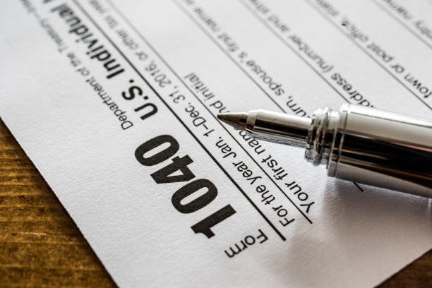 istock US Form 1040 tax return with pen 666152916