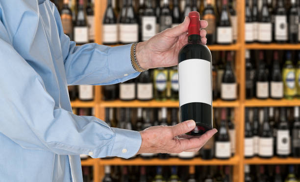 istock Sommelier offering bottle of red wine to customer 666153190