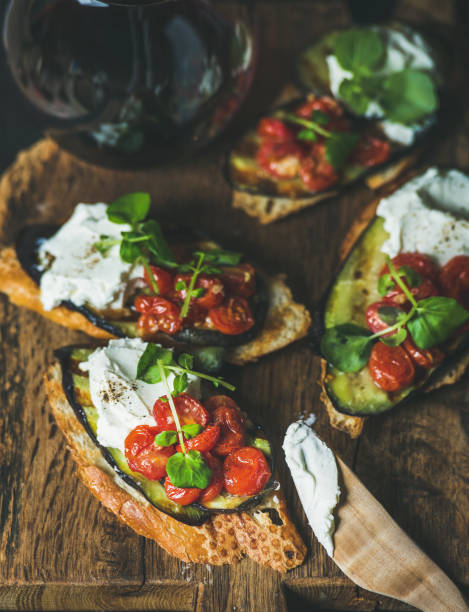 istock Brushetta with grilled eggplant, cherry tomatoes, garlic, cream cheese, arugula 666157000