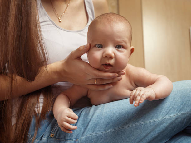 istock A small child lying on my mother's lap 666159430