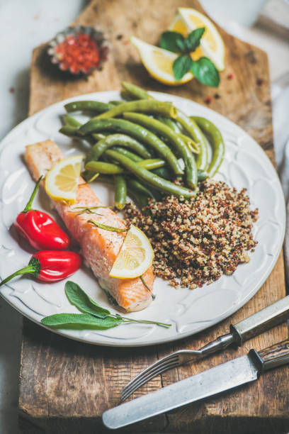 istock Roasted salmon with quinoa, pepper and poached beans in plate 666160326