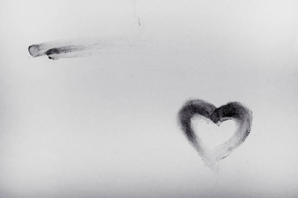 Sketch of heart was drawn by red colored pencil, on white paper.