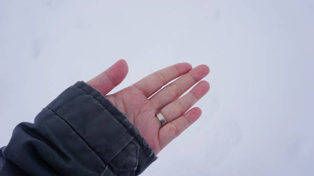 istock woman hand on snow background 666171328
