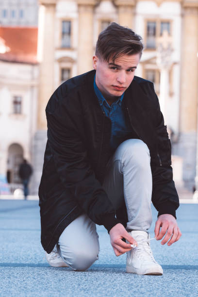 istock Vain boy tying shoelaces on white sneekers 666171764