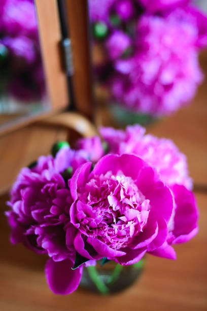 istock Pink peonies in a glass jar 666174774