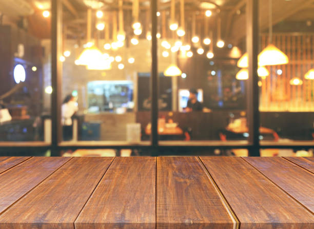 istock Blurred of restaurant with bokeh lights background and wood table 666180930