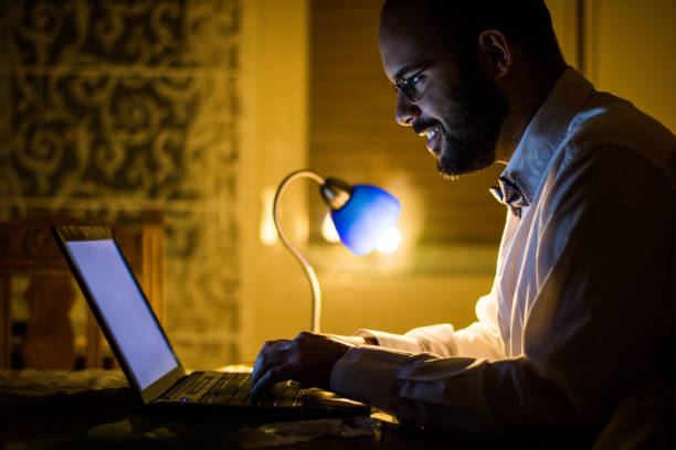 istock Young formalwear man working on laptop late night 666186668