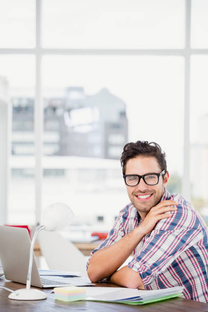 istock Young man sitting at his desk 666187080