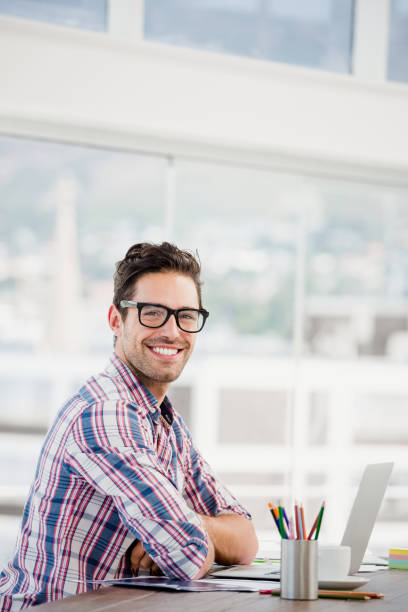 istock Young man sitting at his desk 666187270
