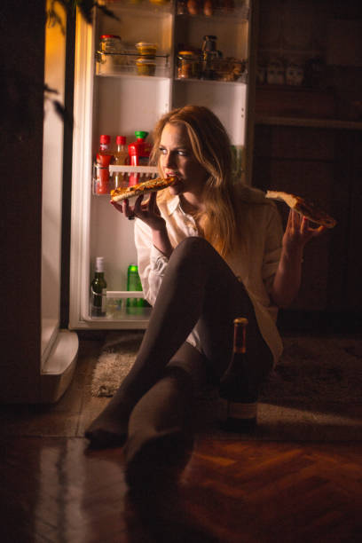 istock Women eating pizza late night 666187416