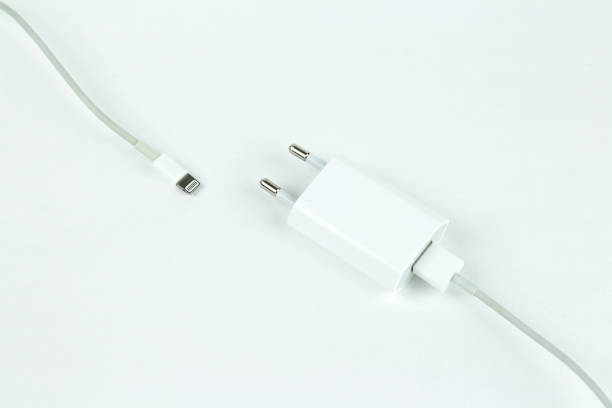 istock Closeup of a white charger and white usb cable. Isolated on a white background. 666187810