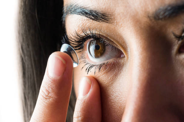 istock Woman about to insert her contact lens 666187904