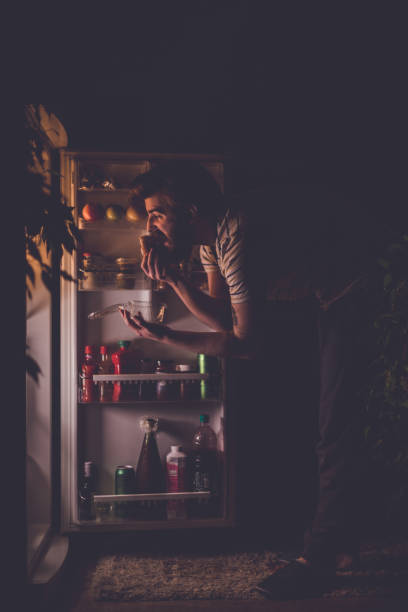 istock Handsome man having snack late night 666188180