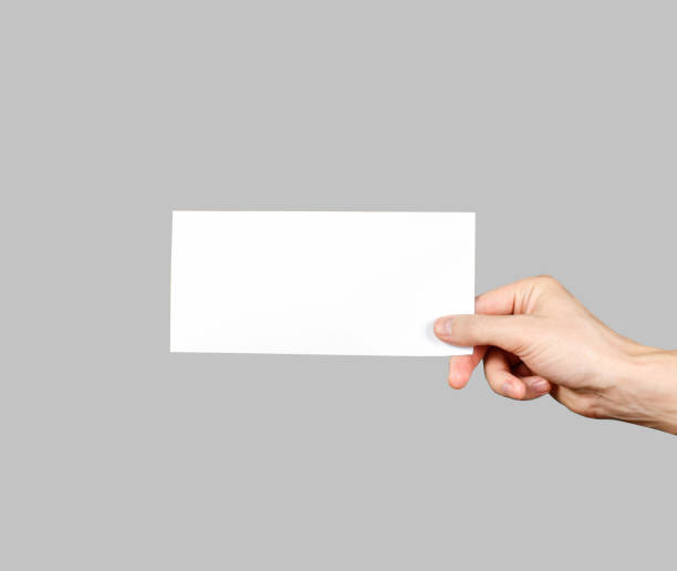 istock Hand holding blank brochure booklet in the hand. Leaflet presentation. Pamphlet hand man. Man show offset paper. Sheet template. Book in hands. Booklet folding design. Fold paper sheet display read 666190232