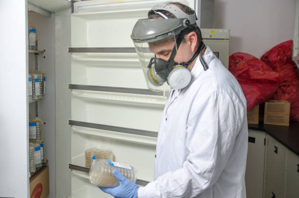 istock Laboratory worker wearing protective equipment taking product in chemistry refrigerator 666190806