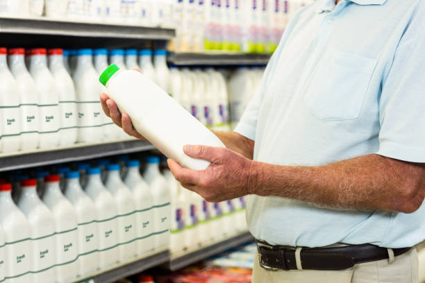 istock Senior man buying milk 666193586