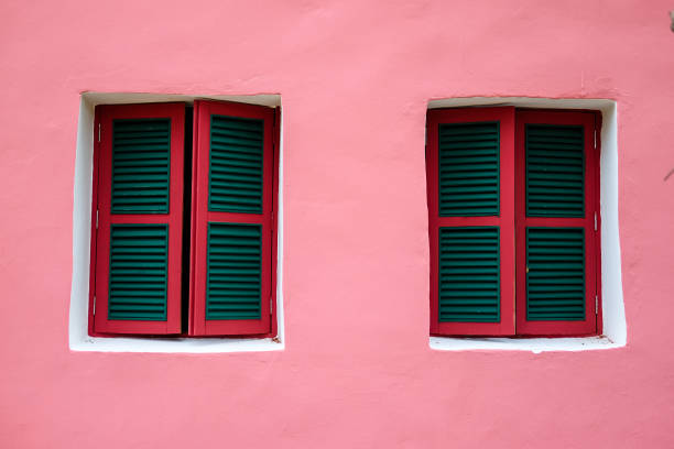 istock Two windows on pink wall, lively style of architecture building 666207978