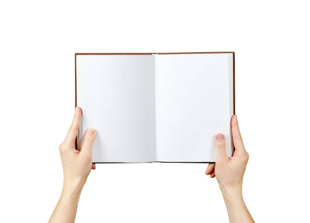 istock Overhead view of hands holding a blank book ready with copy space ready for text. Isolated on white background. With clipping path 666216652