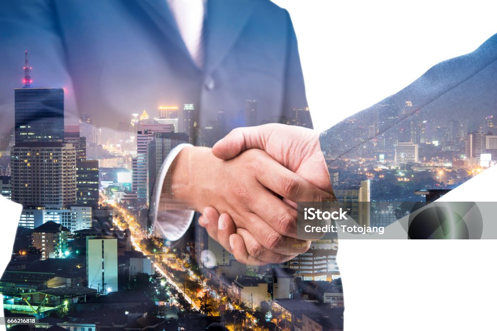 Double exposure of handshake and city night Adult Stock Photo