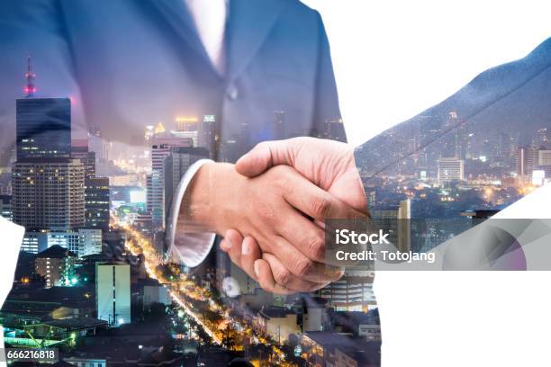 Double Exposure Of Handshake And City Night Stock Photo - Download Image Now - Adult, Agreement, Backgrounds