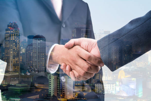 istock Double exposure of handshake and city night 666222882