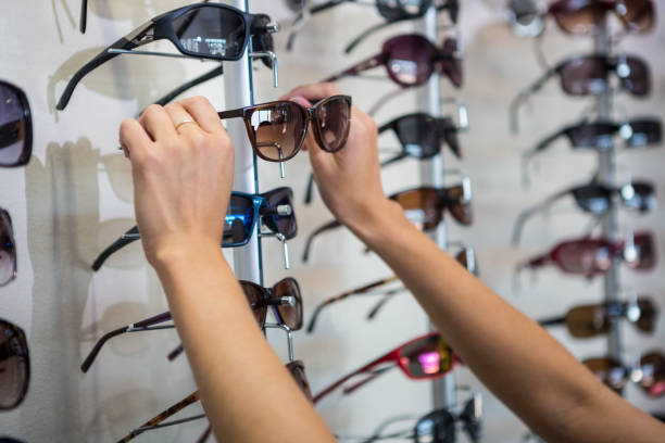 istock Woman picking out new sunglasses 666238828