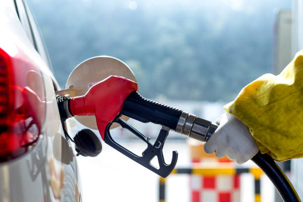istock petrol gun with car 666247936