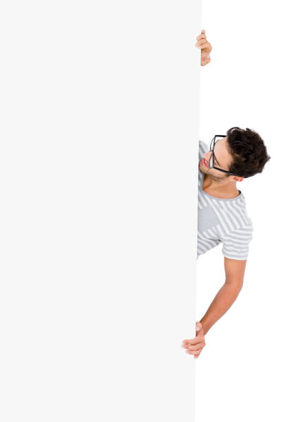 istock Man in spectacles hiding behind the white board 666251834