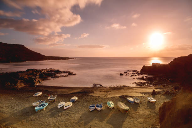 The famous El Golfo coast with some liitle boats on Lanzarote Island on a nice evening.