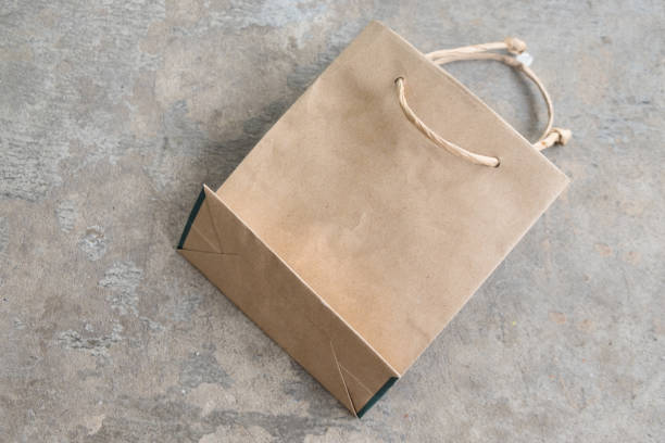 istock Recycled paper kraft shopping bag on concrete background 666256334