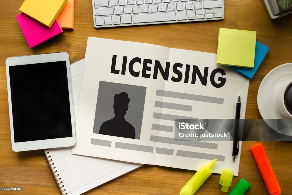 Patent License agreement LICENSING   business man hand working on laptop computer Driver's License Stock Photo