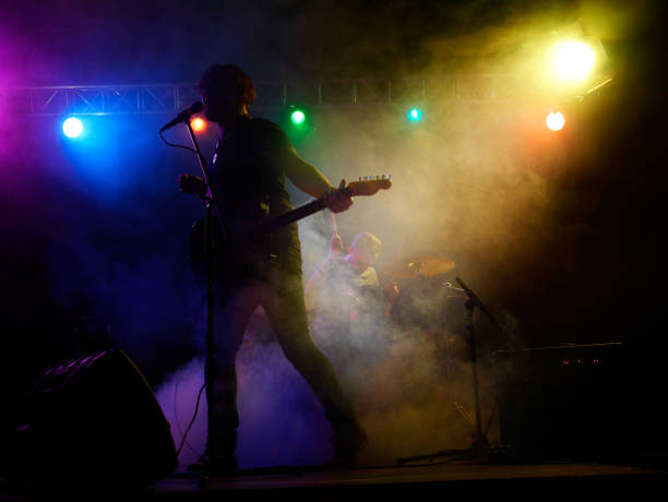 istock Silhouette of guitar player on stage. 666258834