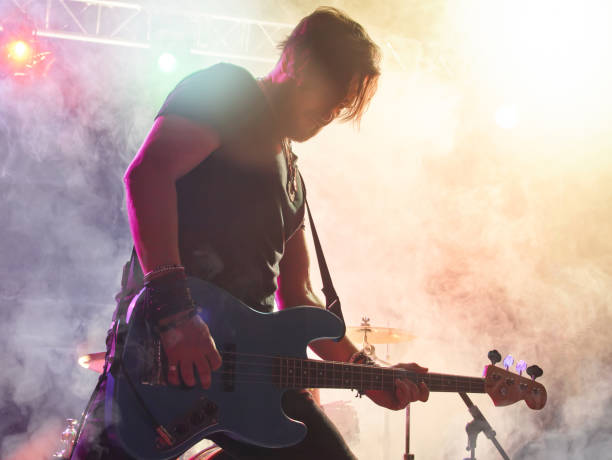 istock Rock band performs on stage. Bassist in the foreground. 666258984