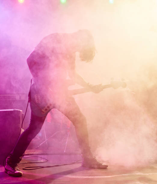 istock Rock band performs on stage. Bassist in the foreground. 666259004
