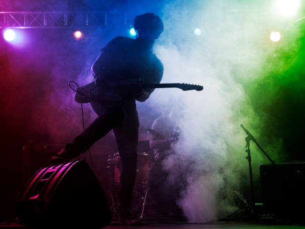 istock Silhouette of guitar player on stage. 666259030