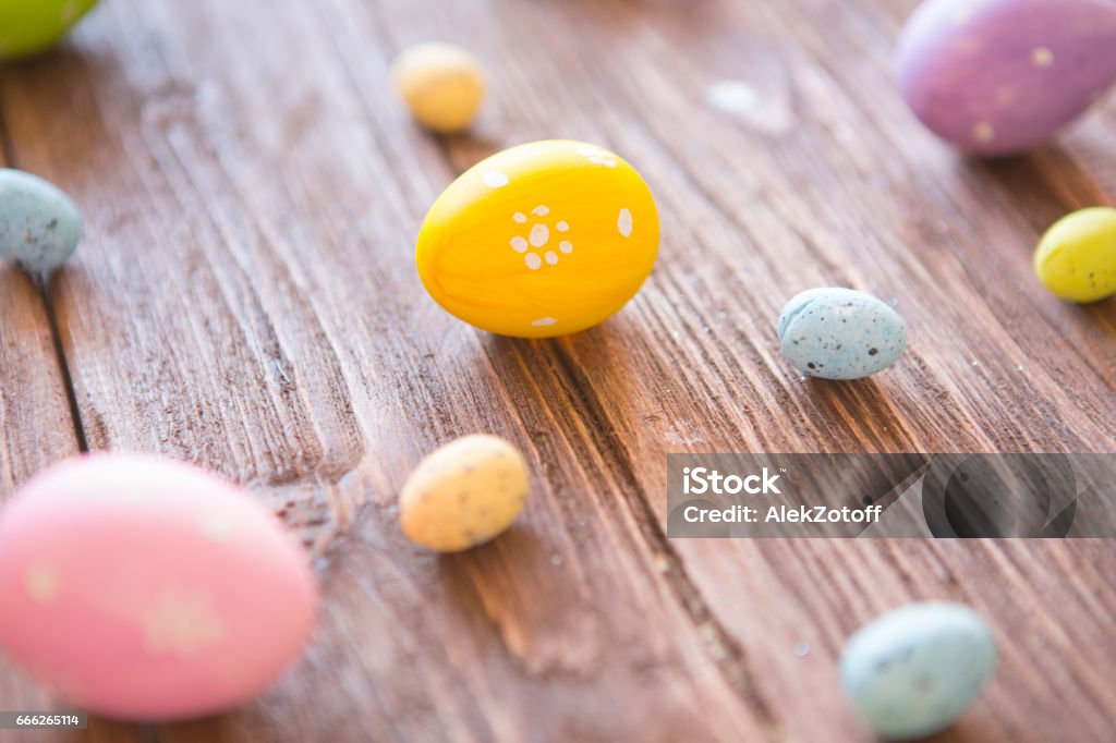 Easter eggs painted in pastel colors on wooden background. Perspective effect. Easter eggs painted in pastel colors on a rustic wooden background. Perspective effect. Abstract Stock Photo