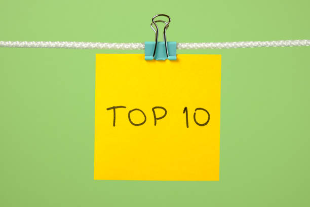 istock Yellow paper sheet on the string with text Top 10 over colorful background 666265638