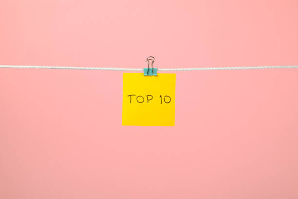 Yellow paper sheet on the string with text Top 10 over colorful background