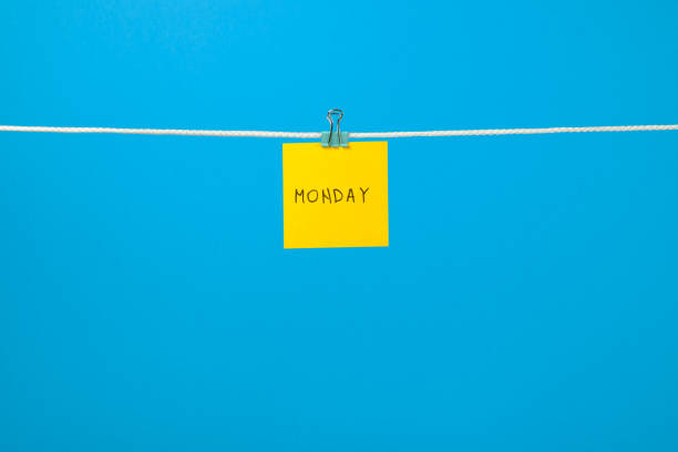 istock Yellow paper sheet on the string with text Monday over colorful background 666265658