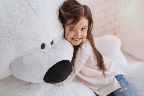 istock Pretty delighted girl hugging her stuffed animal 666268920